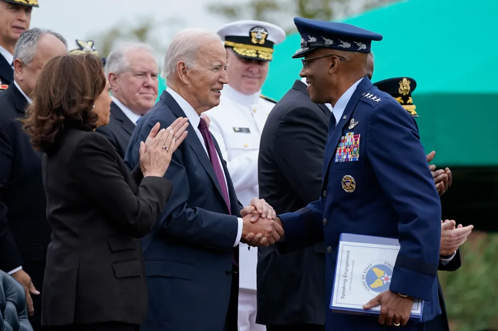 President Joe Bidne shakes hands with Gen. CQ Brown, Jr. as Vice President Kamala Harris looks on during an event at Joint Base Myer-Henderson Hall in Fort Myer, Virginia, on Sept. 29, 2023.