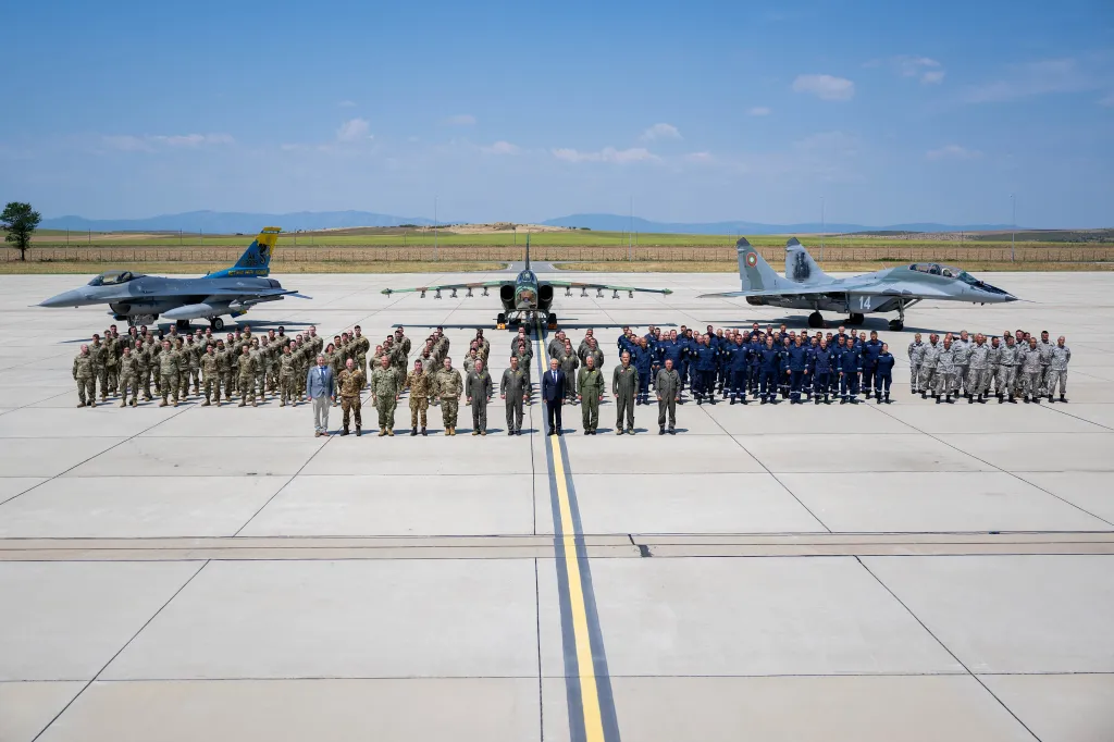 U.S. Air Force Airmen, leadership, and Bulgarian air force members and leaders pose for a group photo on an airfield.