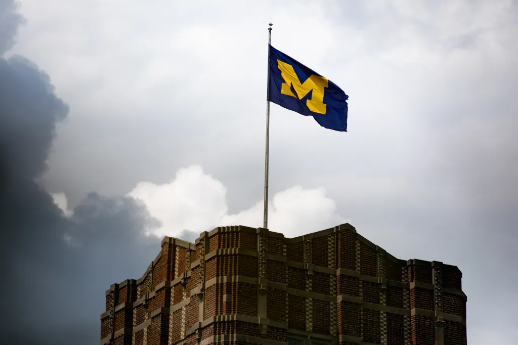A University of Michigan flag is seen on the Michigan Union building at the school's campus in Ann Arbor, Michigan, on Monday, July 28, 2025. The Department of Education opened investigations into five universities to determine whether the schools were granting scholarships only for undocumented students. (Bloomberg)