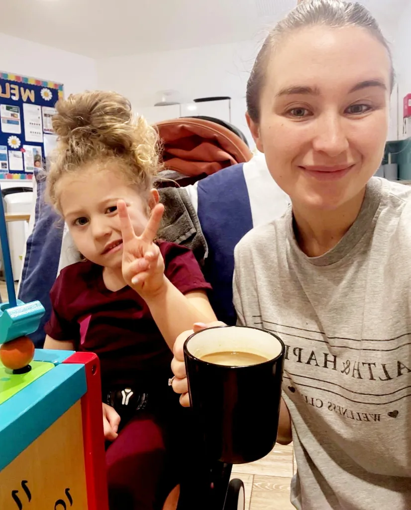 Olivia Elliot, who suffered a stroke, making a peace sign next to her mother Rebecca Elliot, holding a cup of coffee.