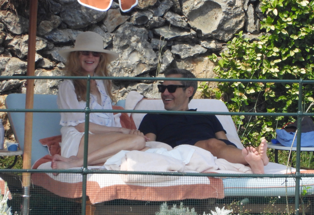 Nicole Kidman and a man relaxing on sun loungers.