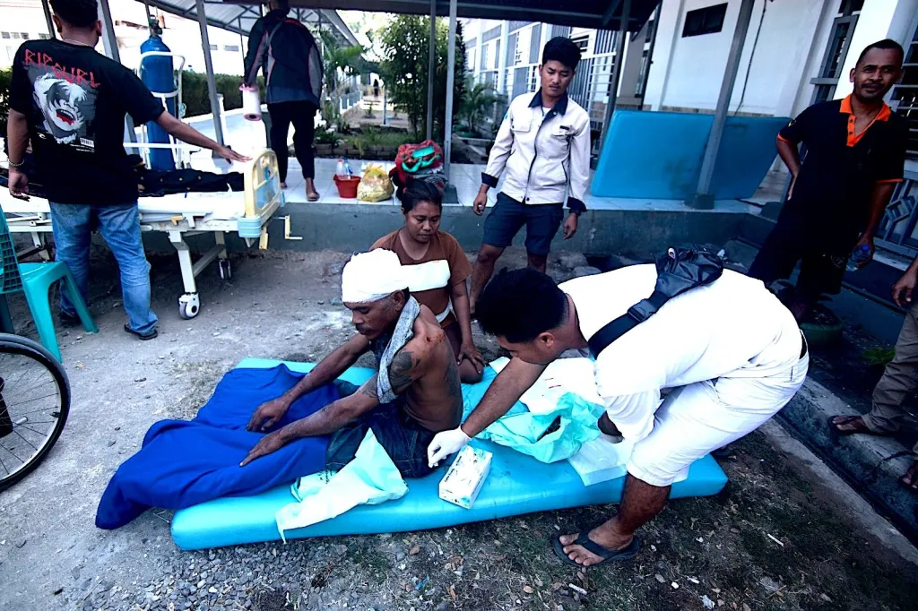 A man is treated for injuries outside a hospital in East Nusa Tenggara province, Indonesia.