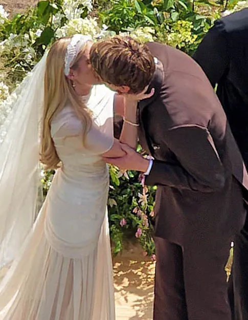 Emma Roberts and Cody John share a kiss at their wedding ceremony.