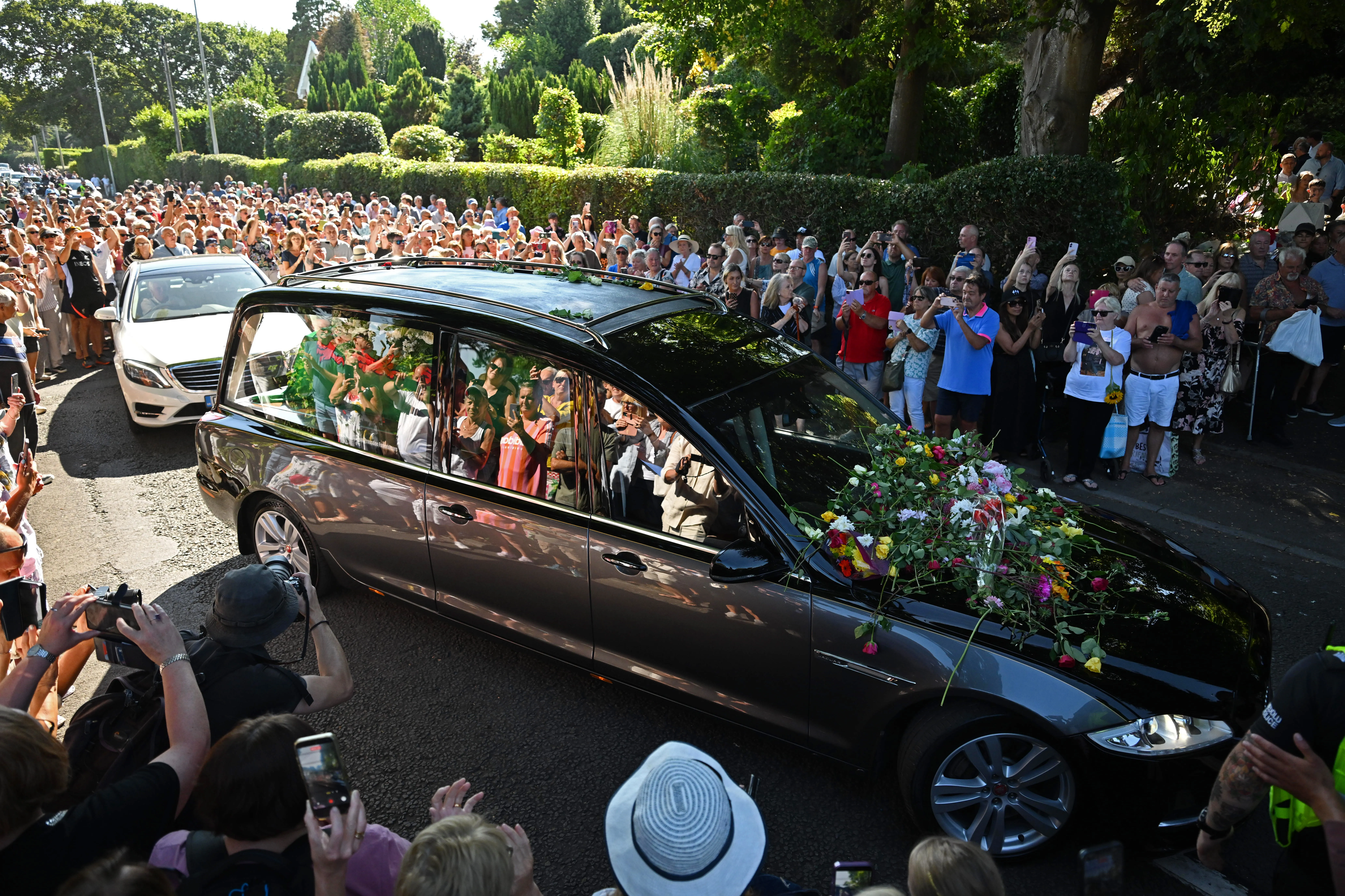 People line the streets as Bonnie Tyler's funeral cortege drives by.
