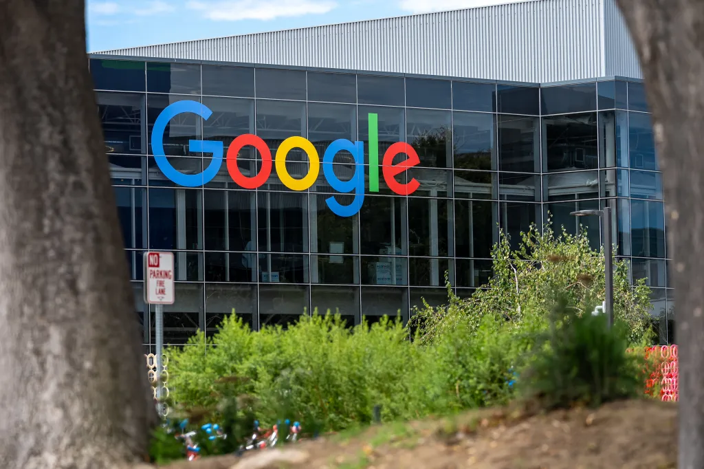 The Google logo on the glass exterior of a building at the Google headquarters.