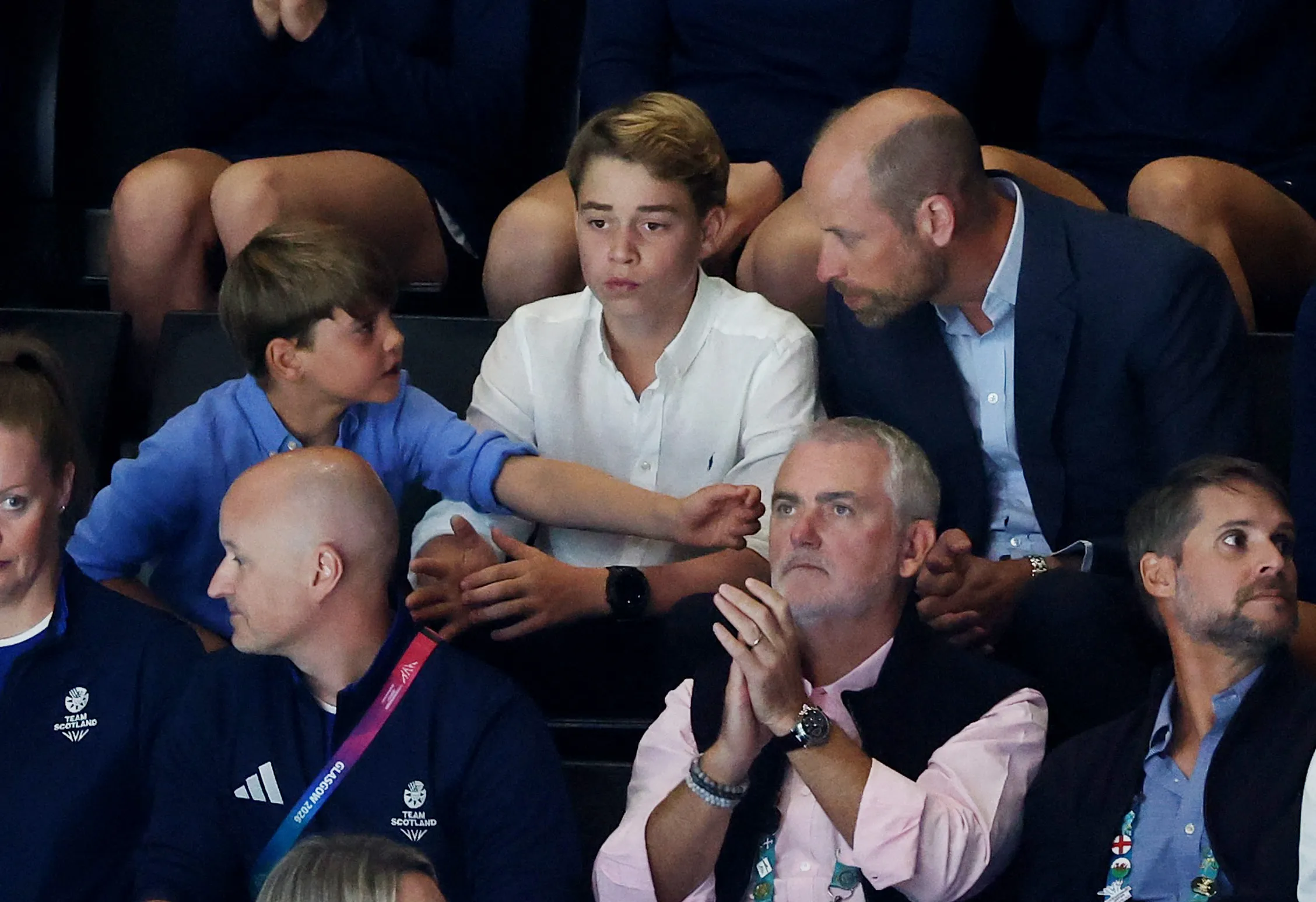 Prince William, Prince George, and Prince Louis in the stands during a netball semi-final match.