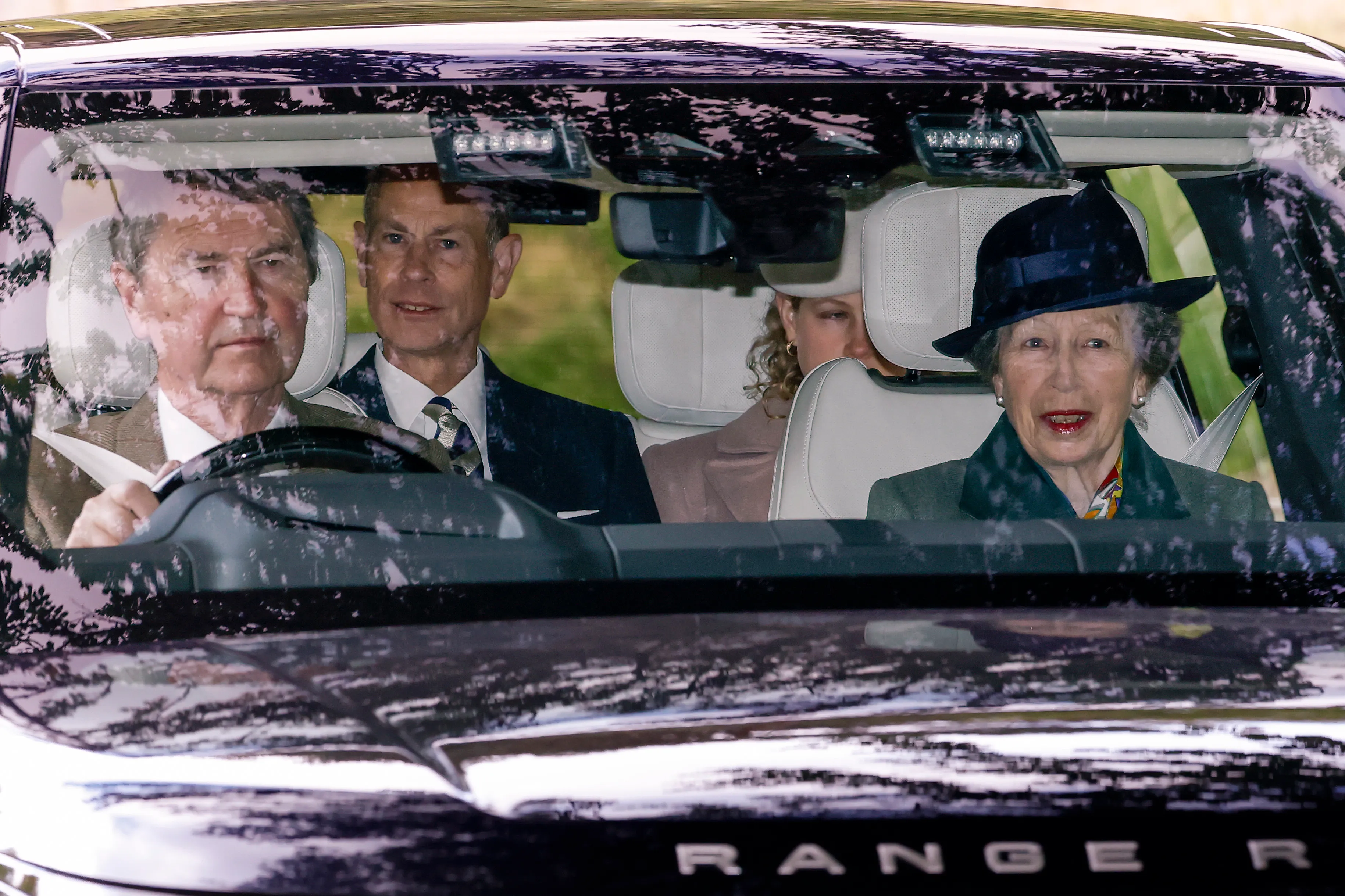 Timothy Laurence, Princess Anne, and Prince Edward in a car in Crathie, Aberdeenshire.