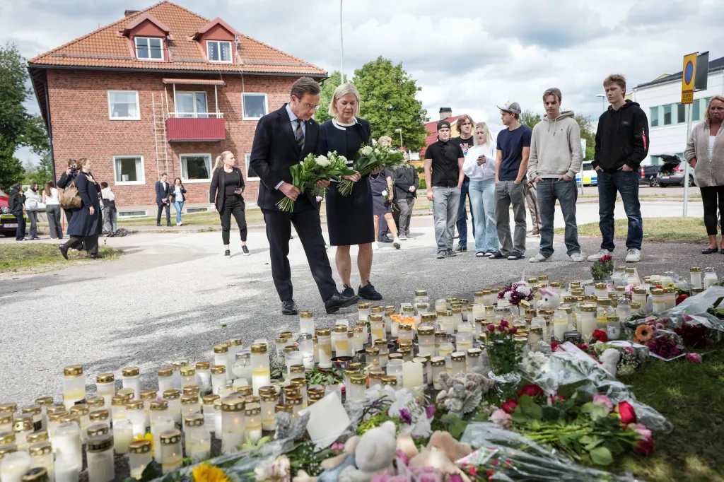 Swedish Prime Minister Ulf Kristersson and Social Democratic Party leader Magdalena Andersson visit a makeshift memorial outside a school in Fagersta, Sweden.