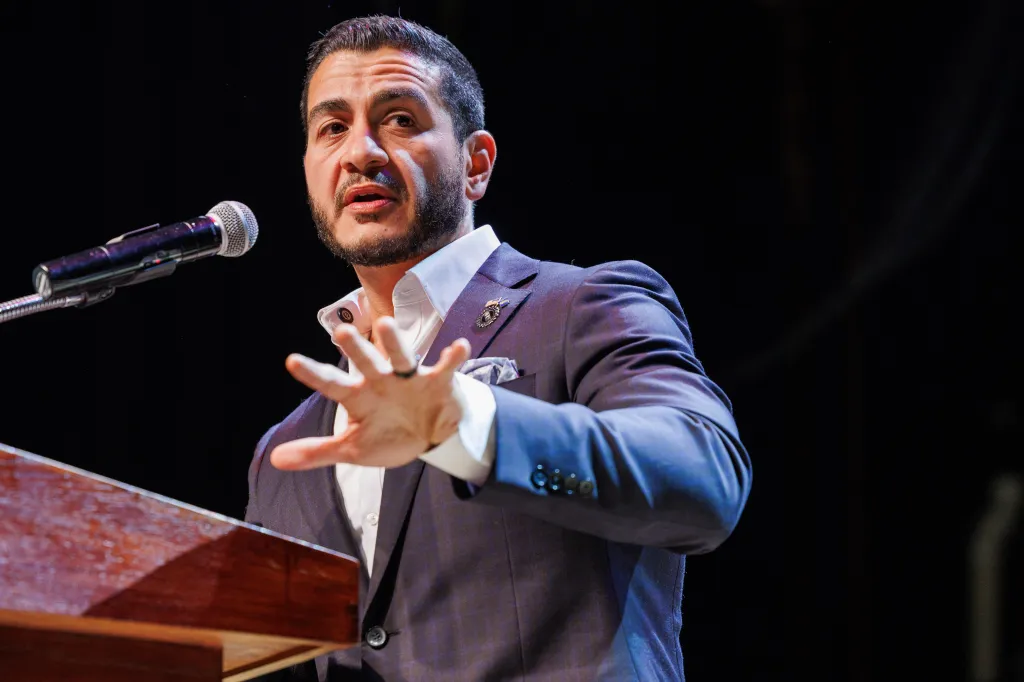 Abdul El-Sayed speaking at a podium during an election night watch party.