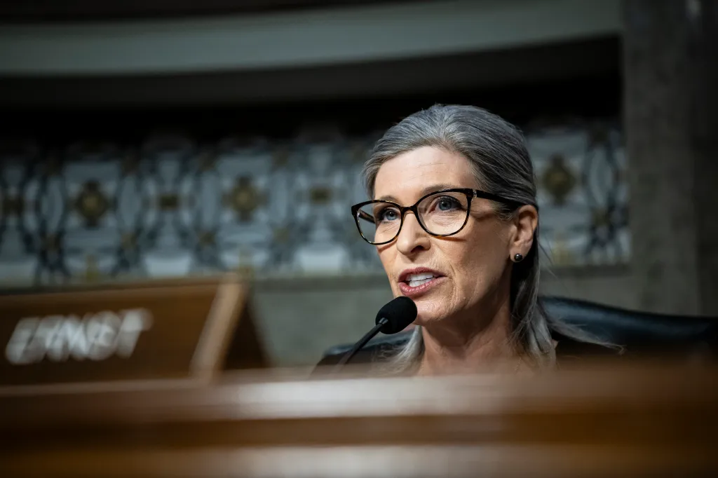 Sen. Joni Ernst (R-IA) speaking into a microphone during a Senate Armed Services Committee hearing.