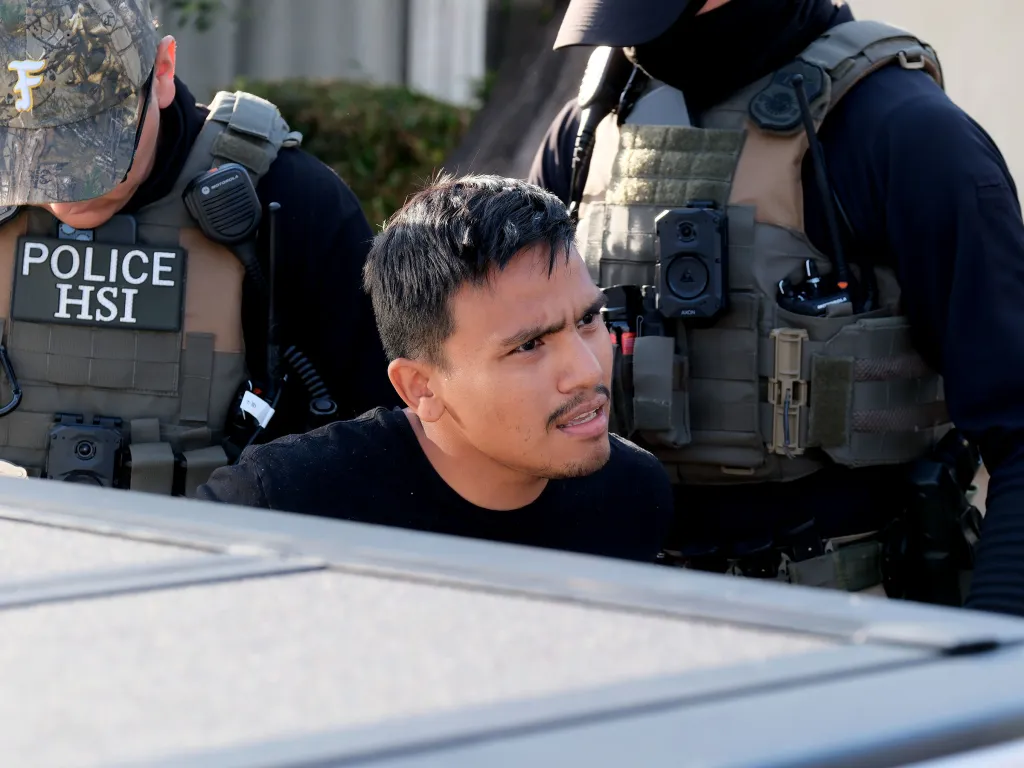 Darwin Rivera-Flores being detained by HSI agents during an early morning raid in Winnetka, CA.