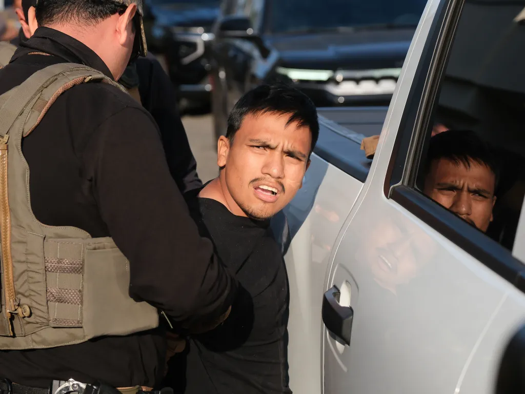 HSI agents arresting Darwin Rivera-Flores in Winnetka, California, in relation to voter fraud.