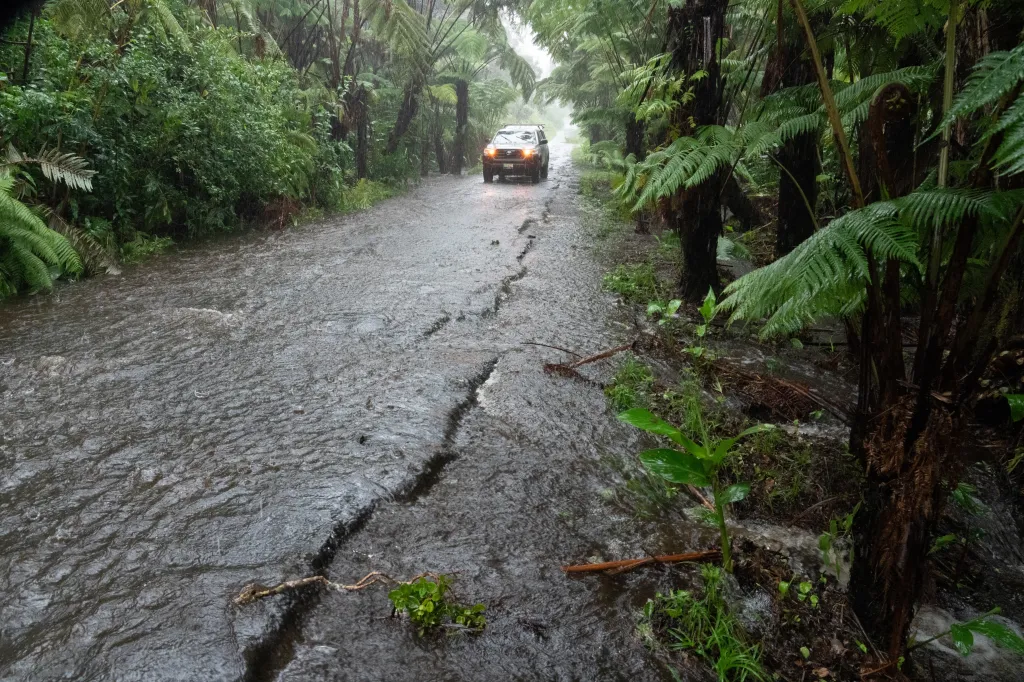 Floodwaters overtake a rural road in Volcano Village on Hawaii Island.