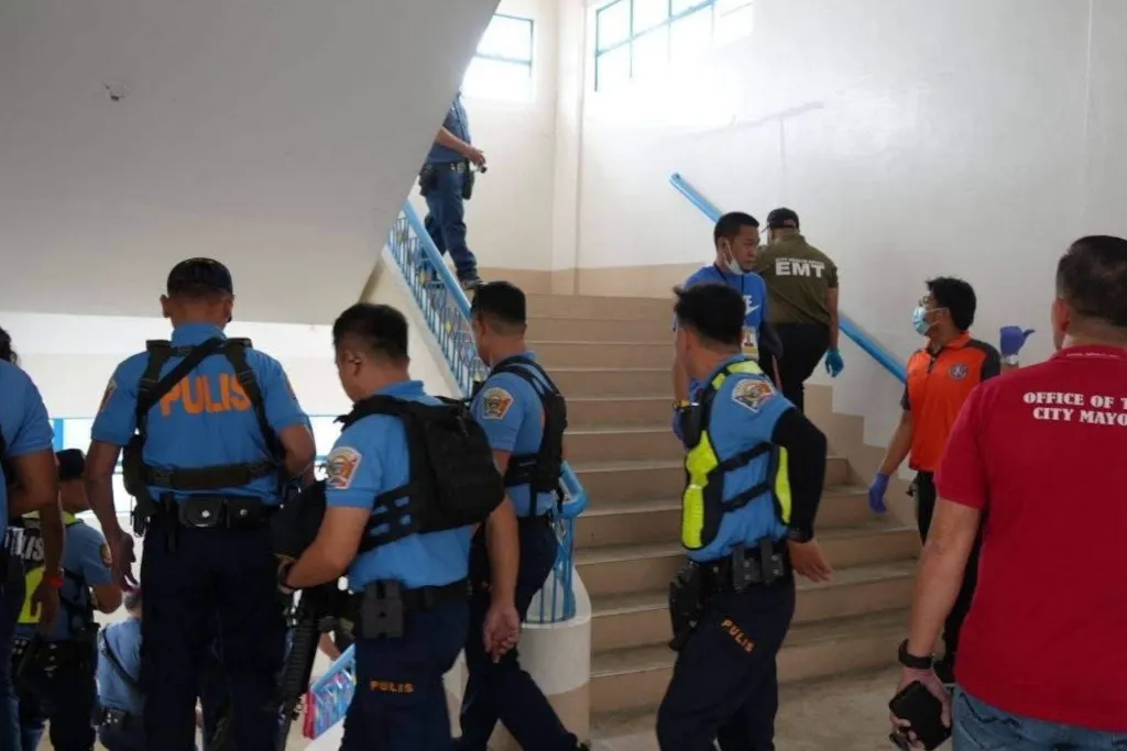 Military personnel and law enforcement officers are seen at the school following a shooting incident on the campus of Ateneo de Zamboanga University High School in Zamboanga City, Philippines, on Tuesday, Aug. 18, 2026.