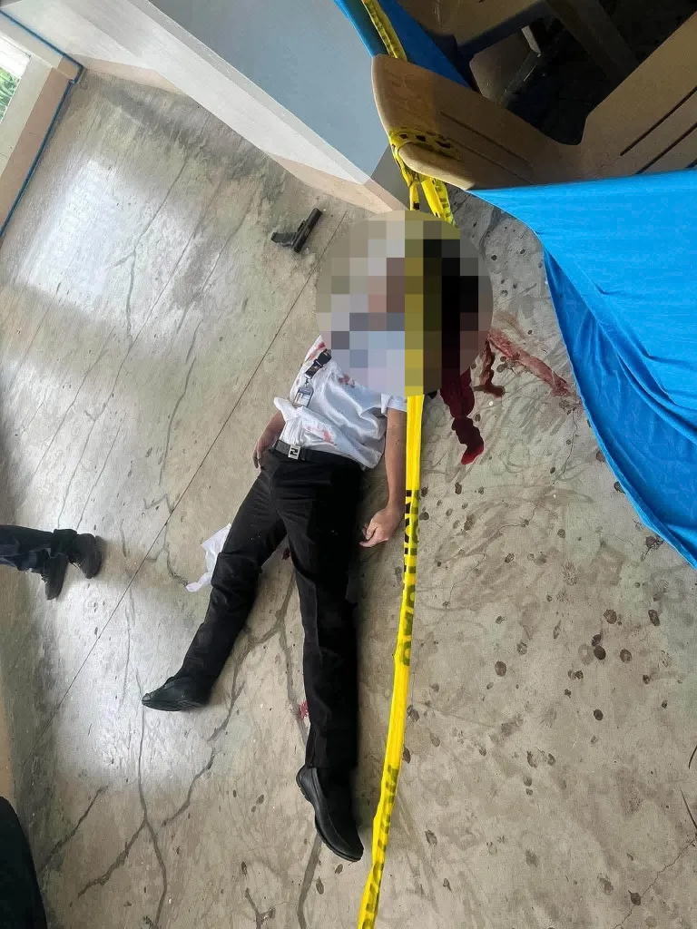 A body lies on the floor as law enforcement officers investigate the scene following a shooting incident on the campus of Ateneo de Zamboanga University High School in Zamboanga City, Philippines, on Aug. 18, 2026.