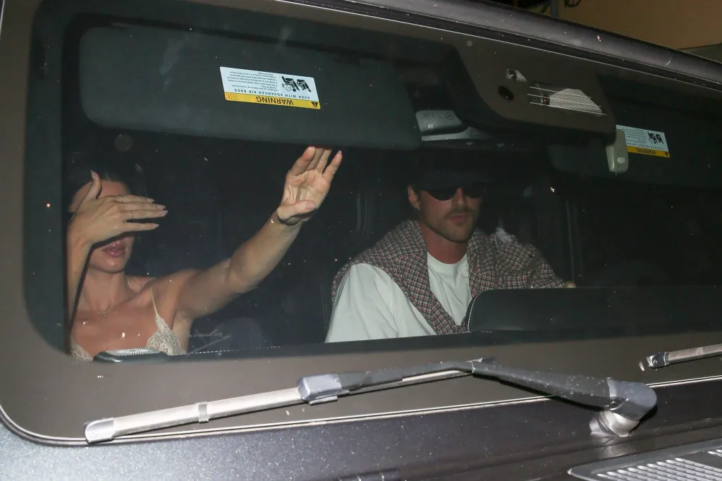 Kendall Jenner shielding her face and Jacob Elordi driving away in a car after their romantic dinner.