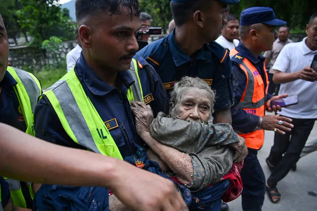 Rescue personnel carry a person affected by flash floods in Nepal's Nuwakot district.