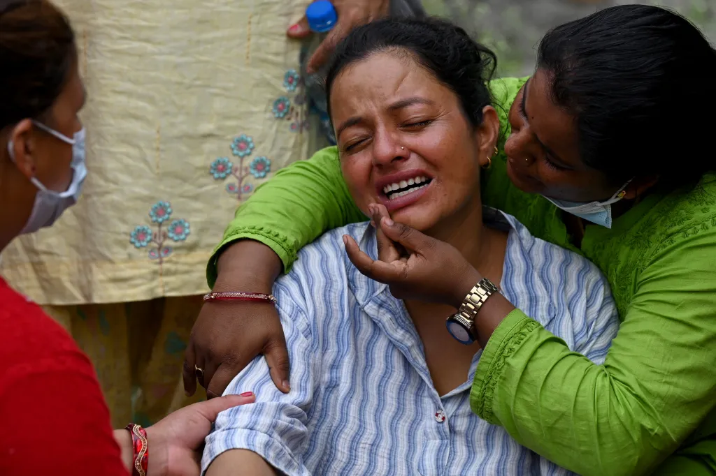 Nepal was burying some of the hundreds of bodies retrieved after a deadly flood crashed through the Himalayan region, sweeping away villages and leaving thousands still missing.