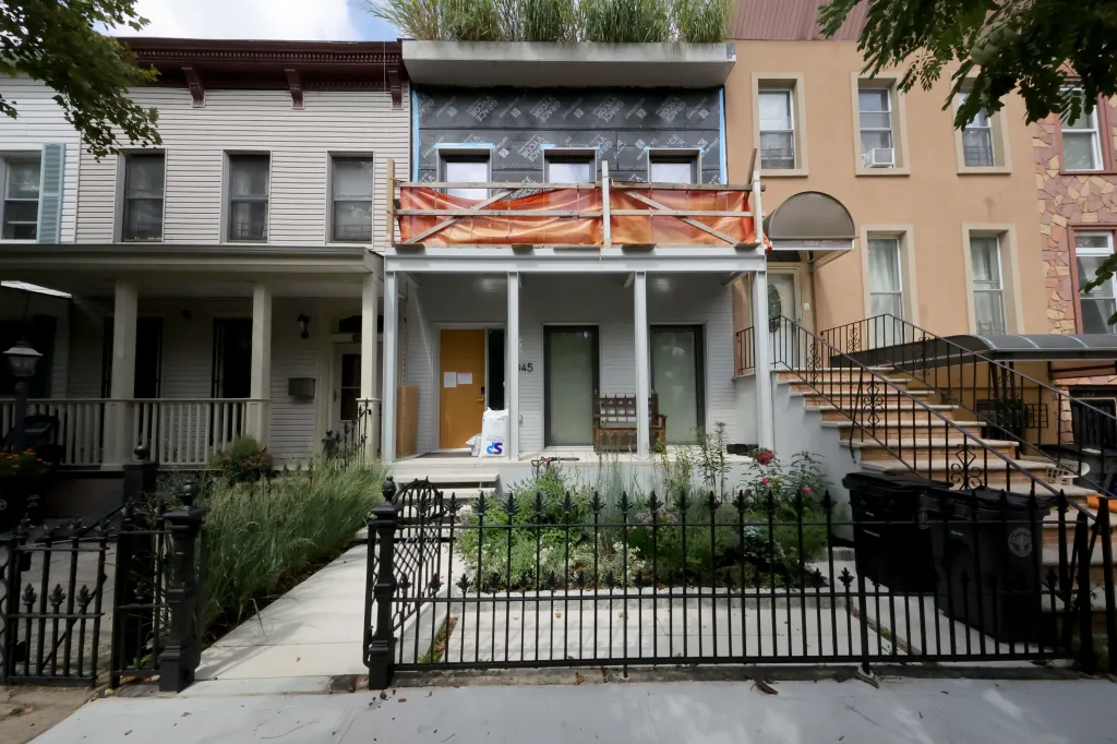 Gustavo Gordillo's Brooklyn residence with ongoing renovation work and a stop-work notice affixed to the door.