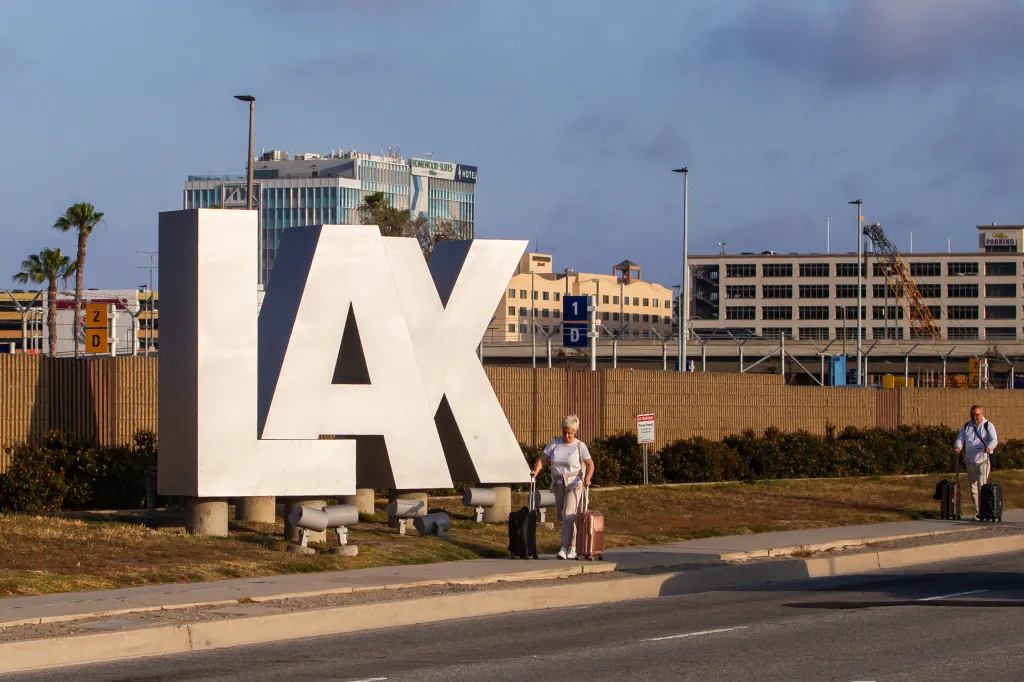 Passengers roll their luggage on Sepulveda Blvd near Los Angeles International Airport (LAX).