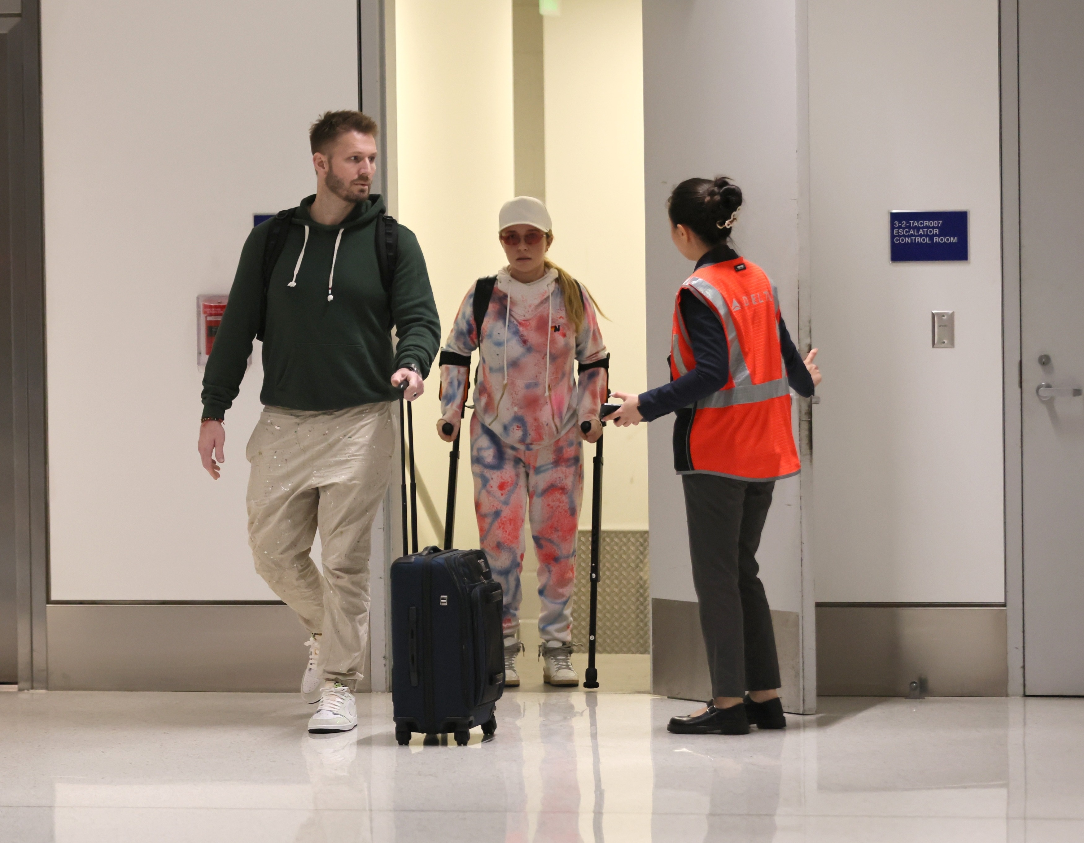 Hayden Panettiere on crutches with Brian Hickerson and an airport attendant.
