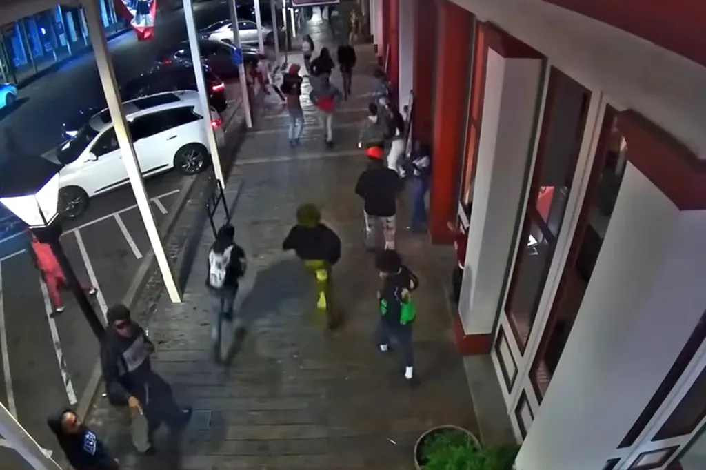 Surveillance video of people near the scene of a stabbing.