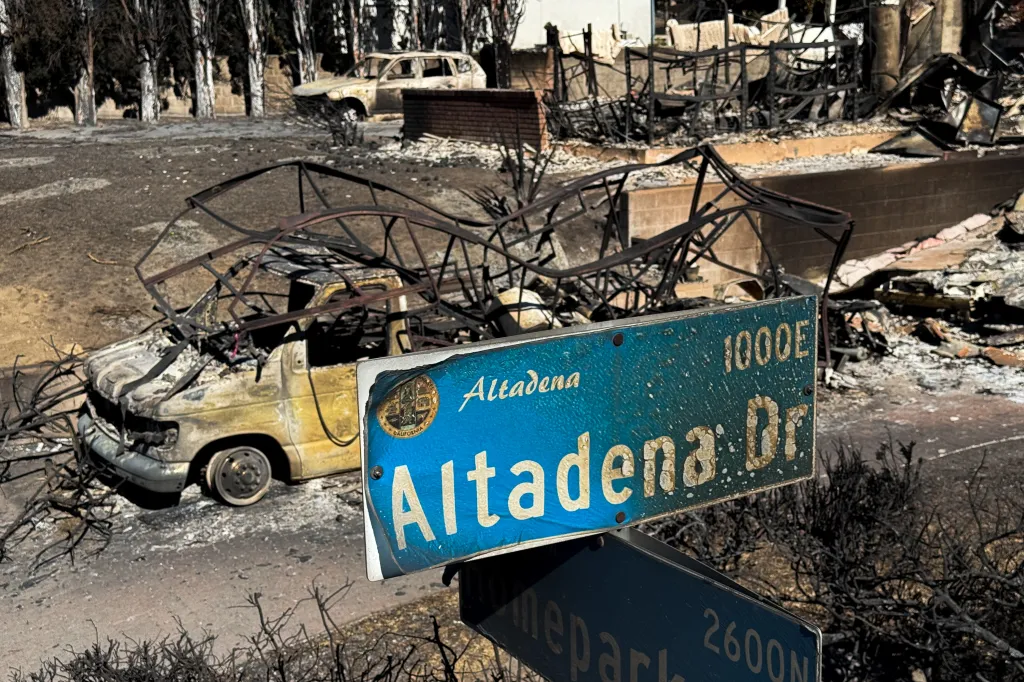 An Altadena Drive street sign and home destroyed by the Eaton Fire.