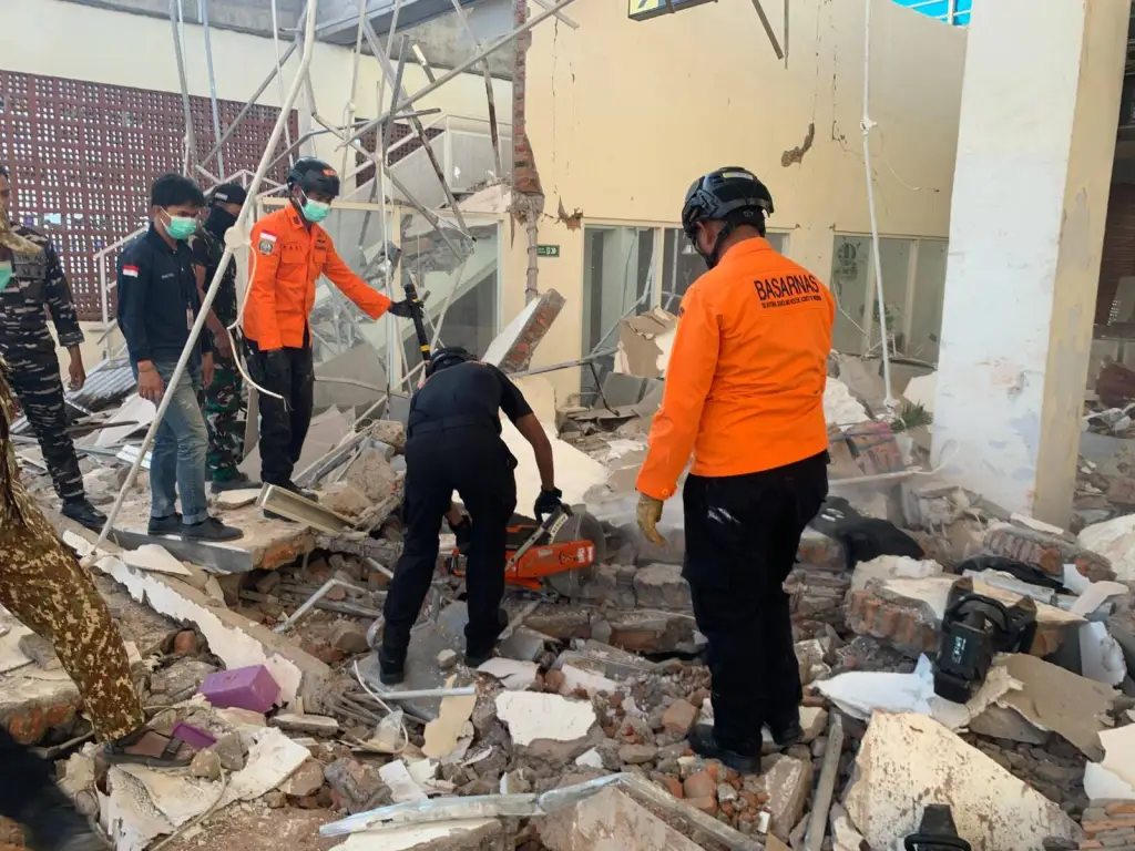 Rescuers search for survivors through the rubble of a collapsed building after an earthquake struck off the coast of Indonesia on Aug. 15, 2026.