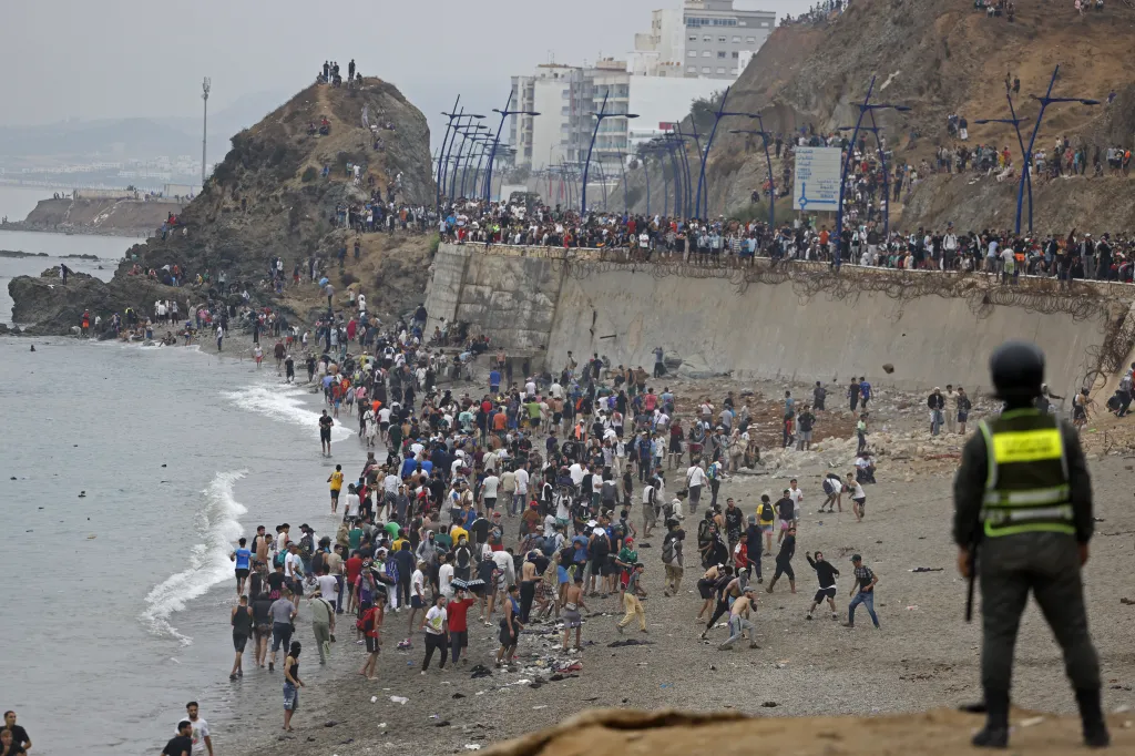 People gather along the Morocco-Spain border fence near Fnideq.