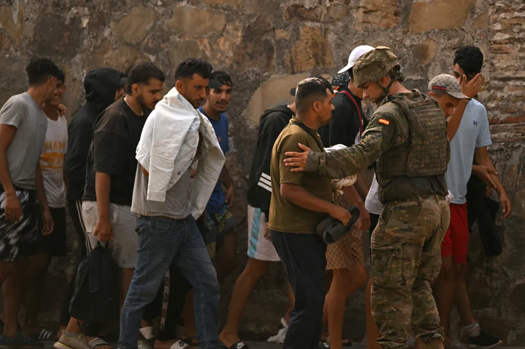 Spanish soldiers control a group of migrants on their way back across the Moroccan border in the exclave of Ceuta on Aug. 1, 2026.
