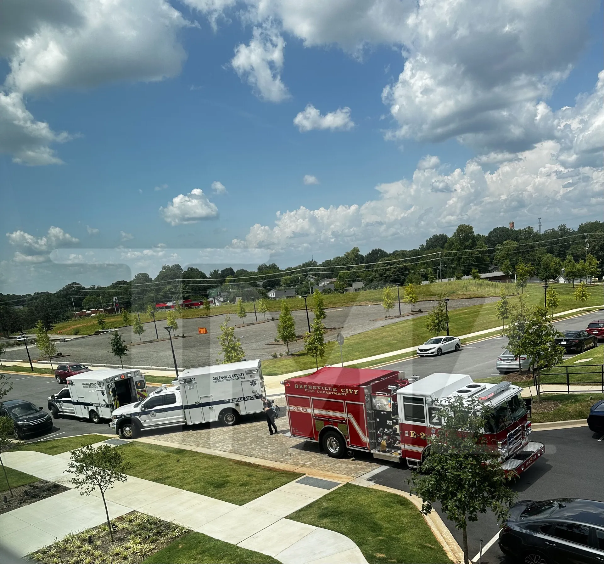 Fire truck and two Greenville County ambulances at a scene.