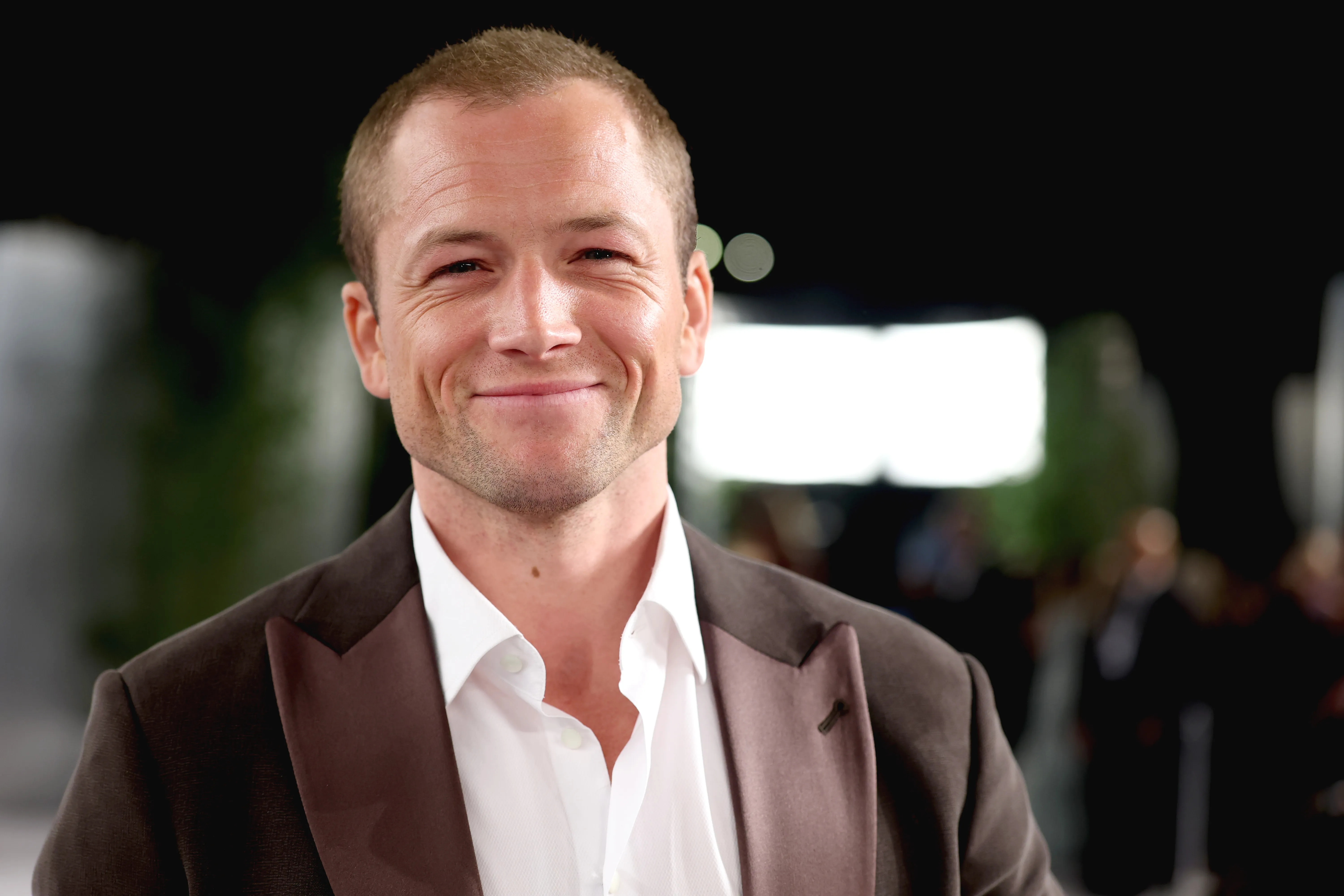 Taron Egerton smiling at the 2026 Vanity Fair Oscar Party.