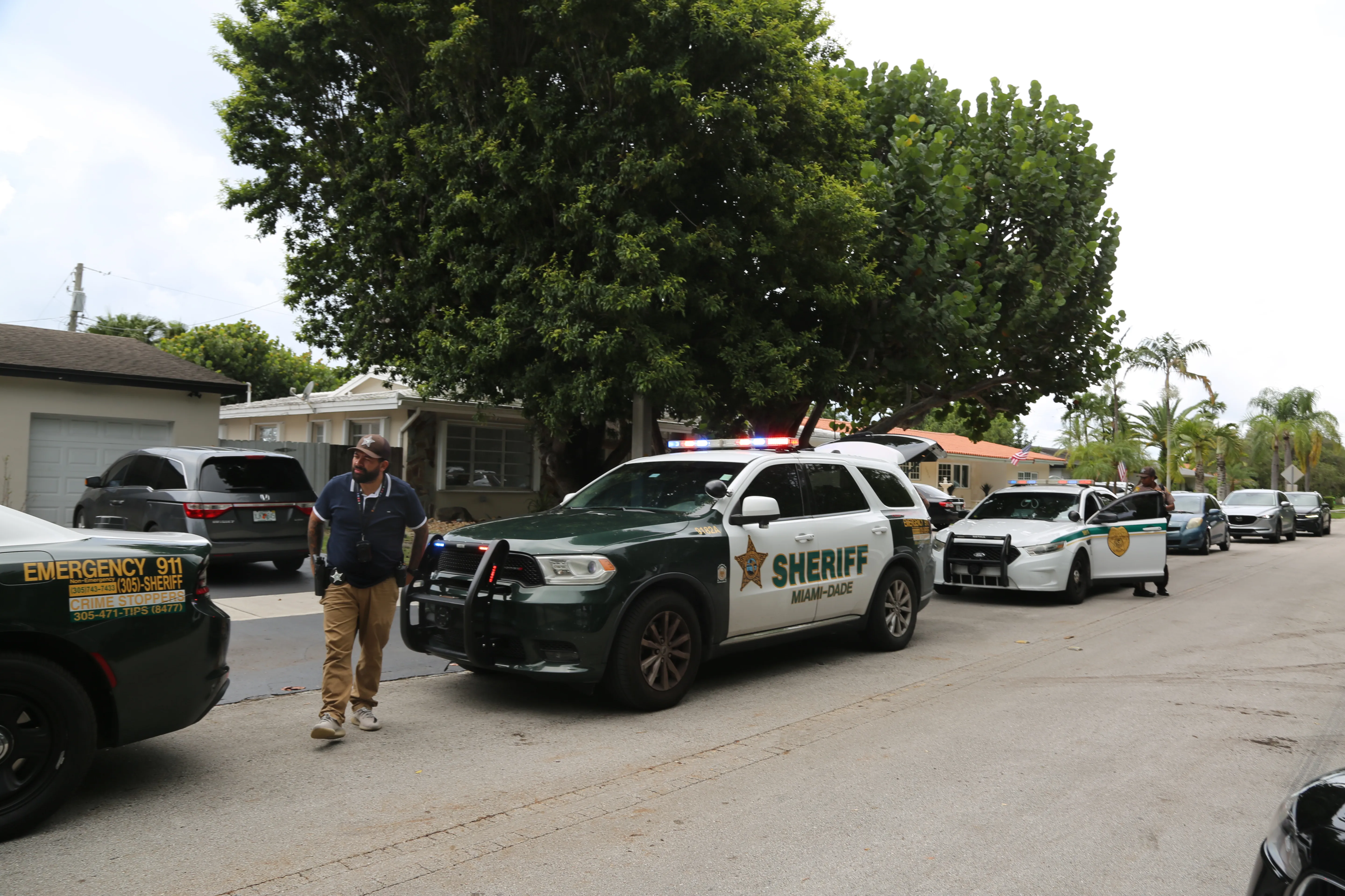 Miami-Dade County Sheriff's deputies outside the home of Perez Hilton.