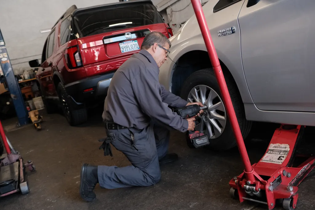 Miguel Sr. changing a tire in Long Beach, California.
