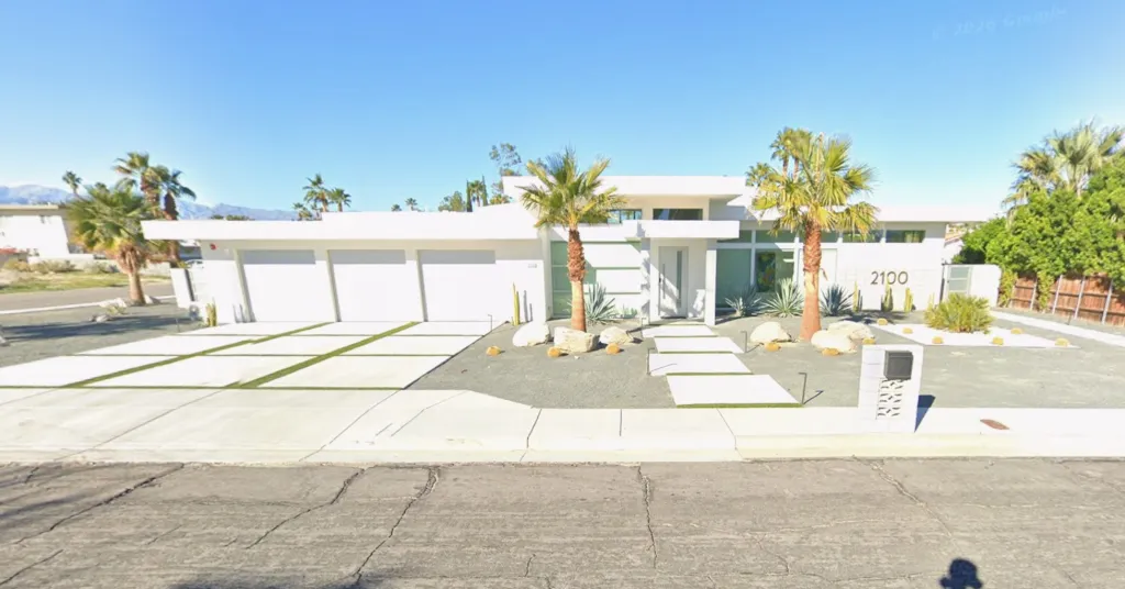 Modern white house at 2100 E Sahara Rd, Palm Springs, CA, with desert landscaping.