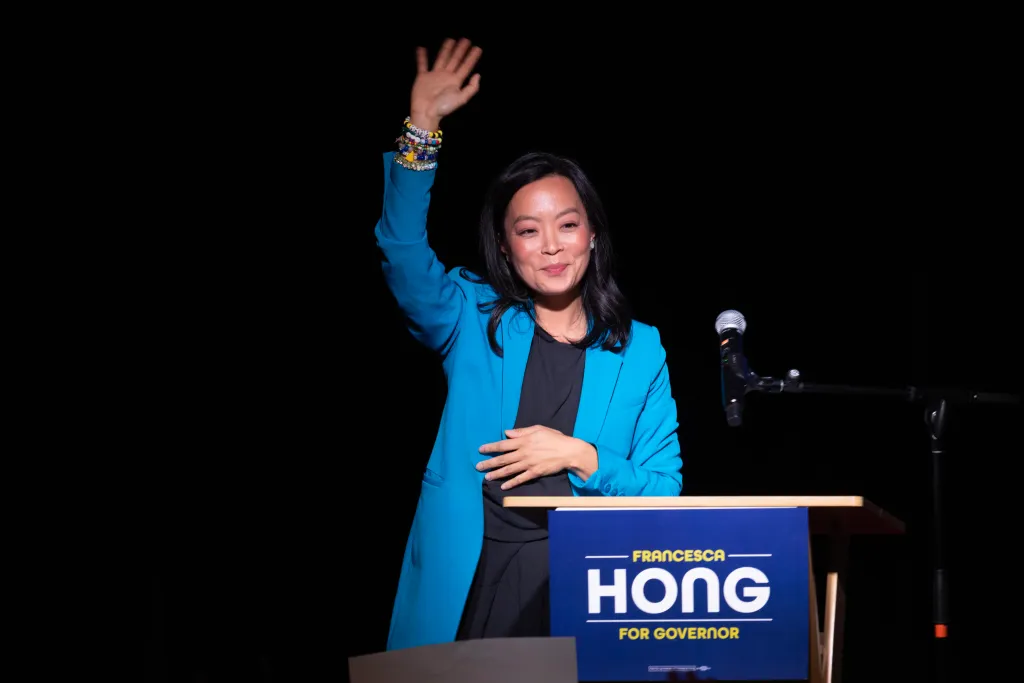 Francesca Hong, a Wisconsin gubernatorial candidate, waves to the crowd at her primary election night event.