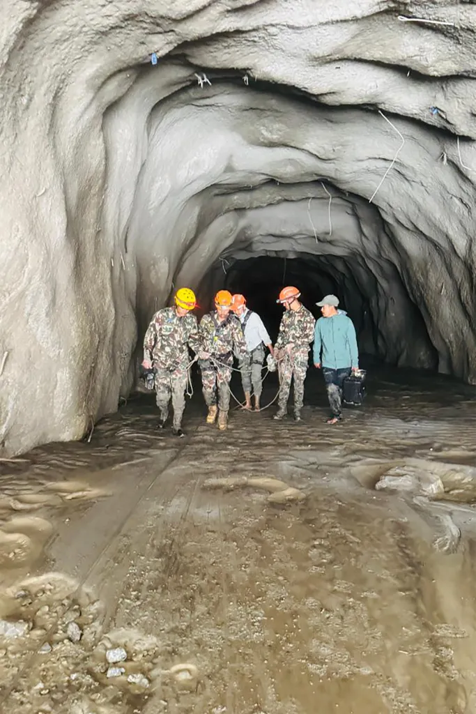 Nepali soldiers walking inside a tunnel to rescue workers after flash floods at Rasuwagadhi Hydropower Project in Rasuwa district.