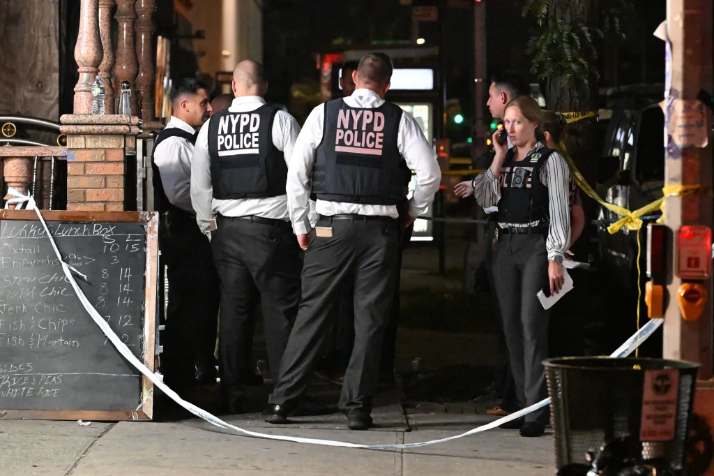 NYPD officers at a crime scene where a 17-year-old boy was fatally shot in Brooklyn, New York.