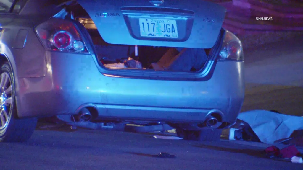 The trunk of a silver Nissan Altima with an Oregon license plate 