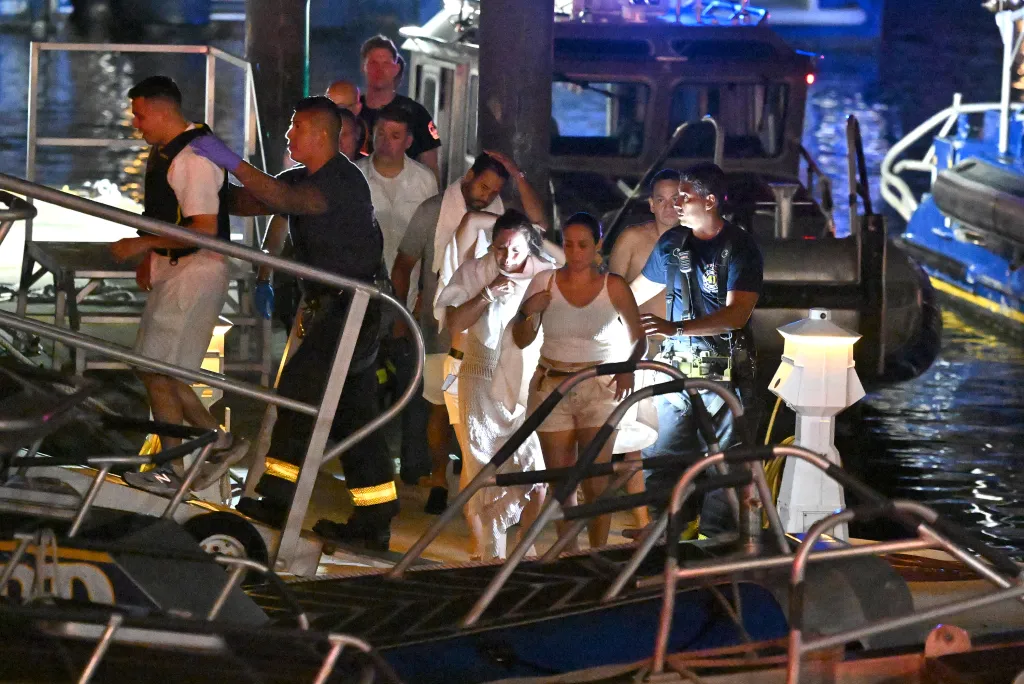 Rescuers assist survivors of a capsized vessel off Liberty Island.