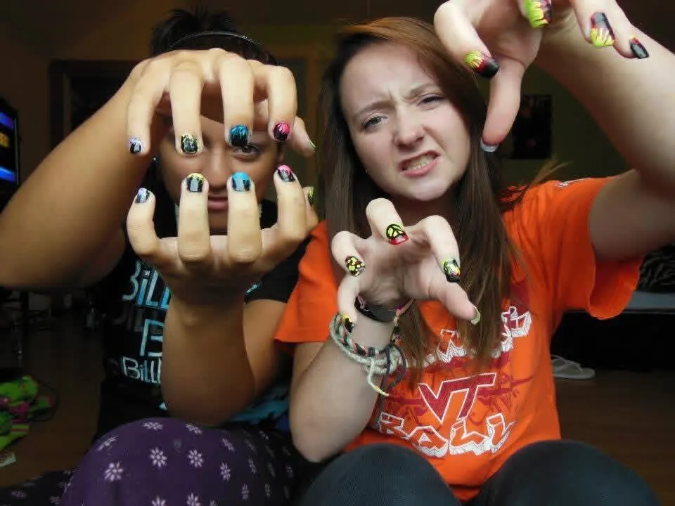 Hope Hobbs and a friend in high school, showing off their painted fingernails.