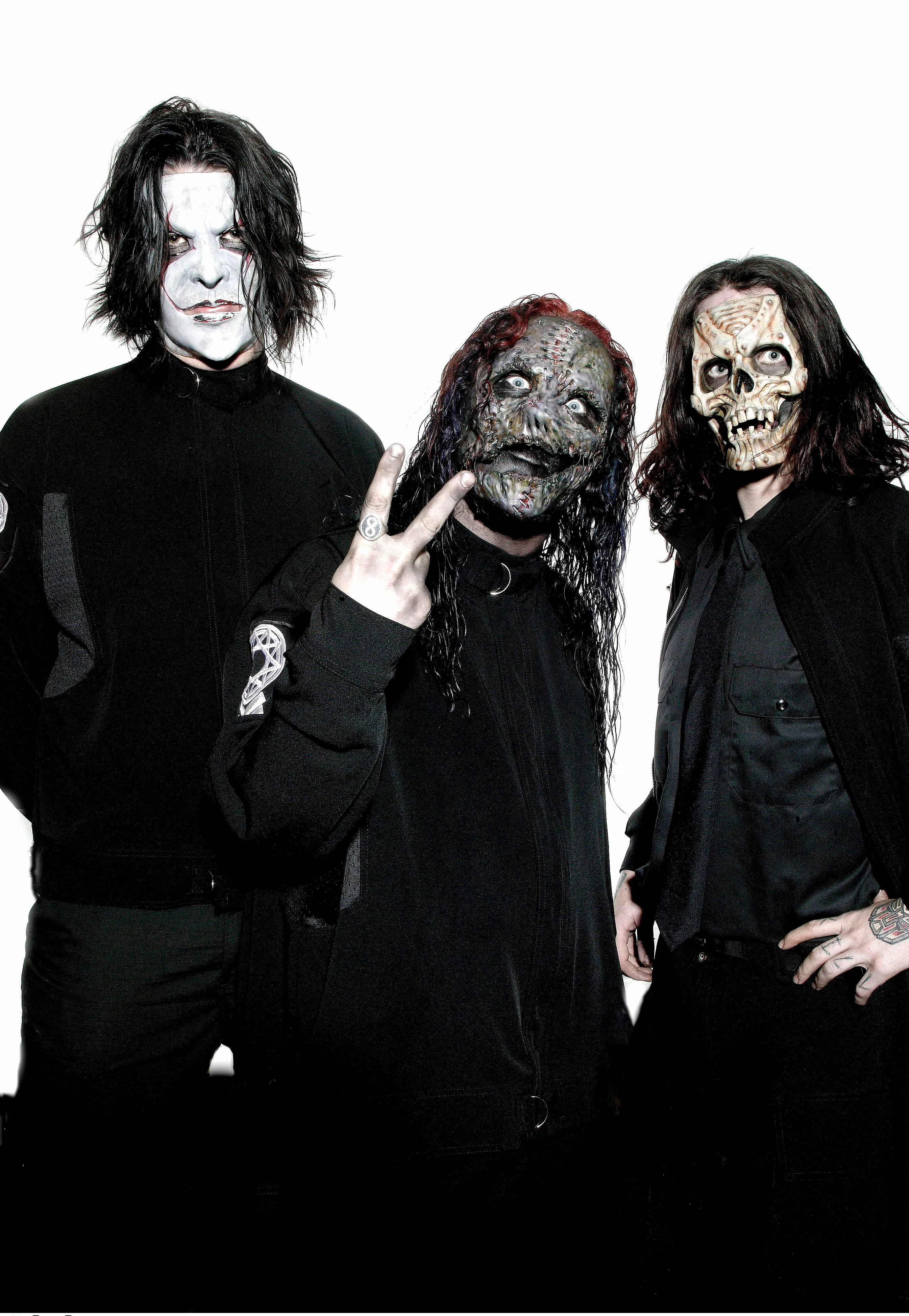 James Root, Corey Taylor, and Sid Wilson of Slipknot in full makeup and masks.