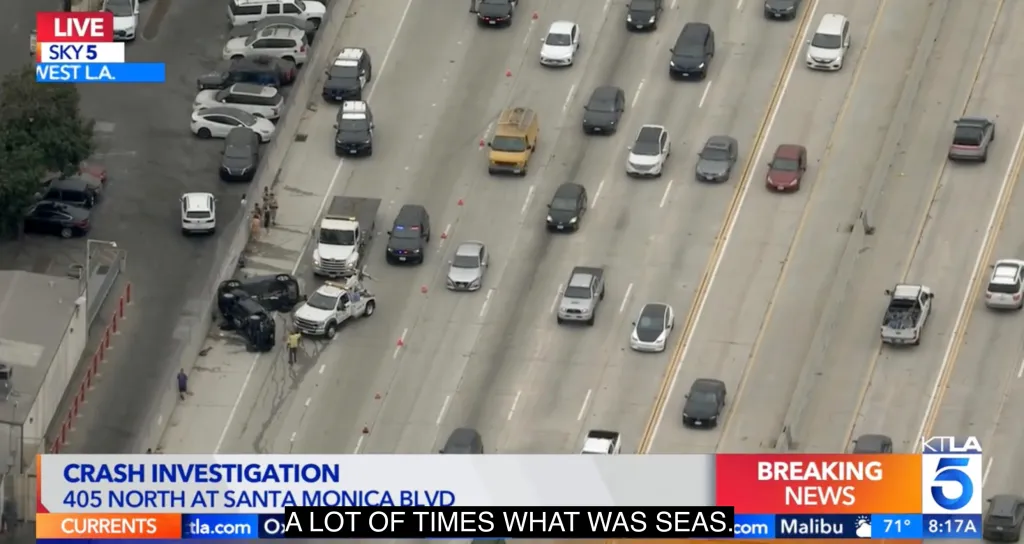 Aerial view of two overturned cars on the 405 Freeway near Santa Monica Boulevard following a crash.