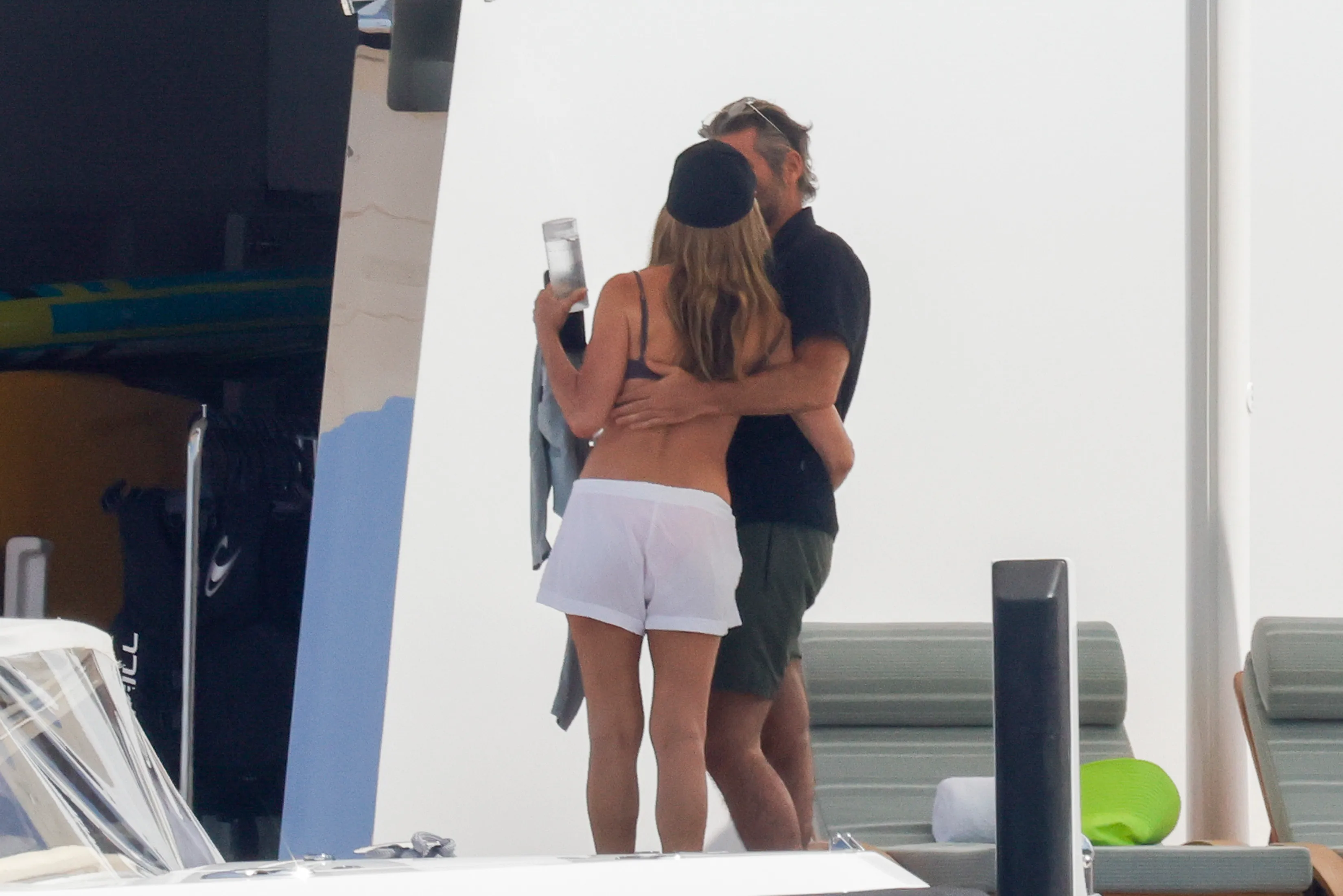 Jennifer Aniston and Jim Curtis embracing on a boat in Mallorca.