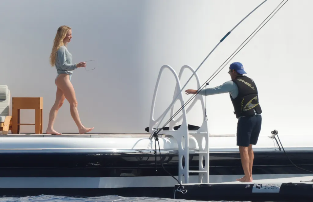 Sydney Sweeney walking past Scooter Braun on a yacht in Mallorca.