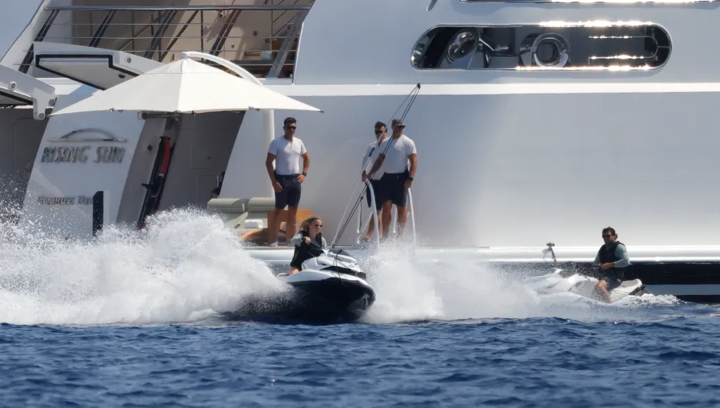 Sydney Sweeney and Scooter Braun jet skiing next to the superyacht Rising Sun in Mallorca.