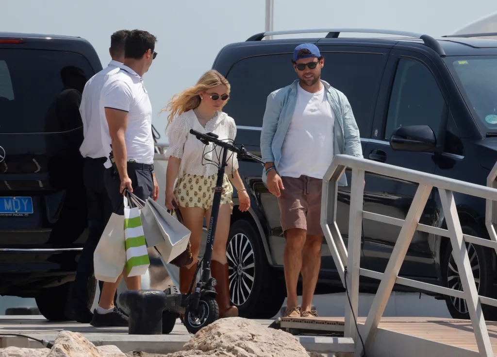 Sydney Sweeney and Scooter Braun walking on a dock in Mallorca.