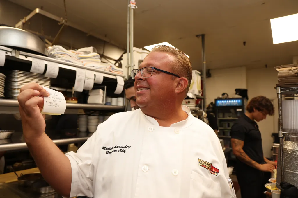 Chef Michael Landesberg of Jackson Hall holding the order for the one-millionth lobster roll.