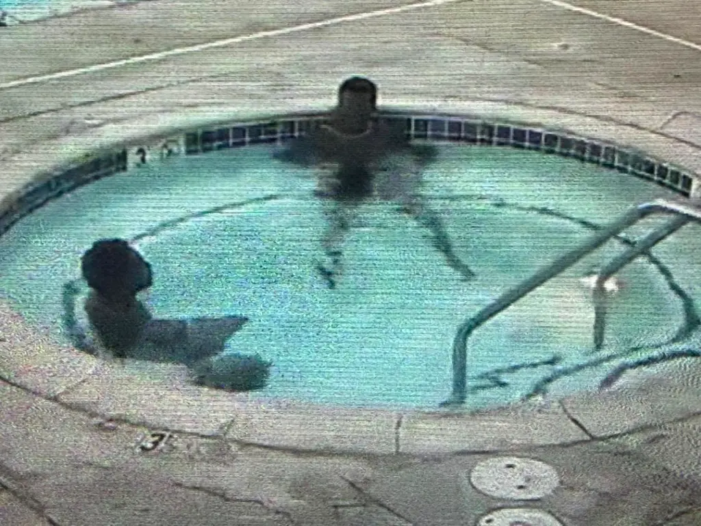 Security camera footage shows Greg Medina relaxing in a hot tub with another person before being attacked.