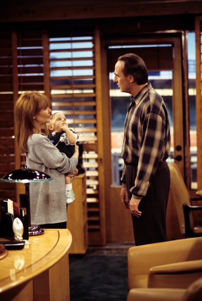 Shelley Fabares holding baby and Craig T. Nelson on the set of 